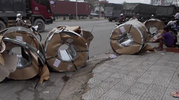 Hàng chục tấn tôn rơi từ xe đầu kéo xuống đường