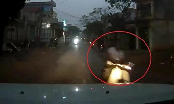 Thanh niên chạy xe máy cắm mặt vào điện thoại, suýt tông trực diện ô tô
