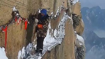 Dọn tuyết trên lối đi rộng 30 cm vắt qua vách núi ở Trung Quốc