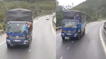 Huế: Hai người đàn ông đánh đu trên đầu xe tải