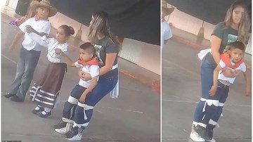Cô giáo buộc chặt cậu bé vào người để tham gia nhảy cùng các bạn