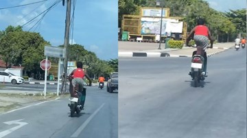 Nam thanh niên ‘tập thể dục’ trên yên xe máy giữa phố