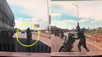 Thanh niên đèo bạn gái núp bóng xe tải tránh nắng còn khiêu khích xe khác