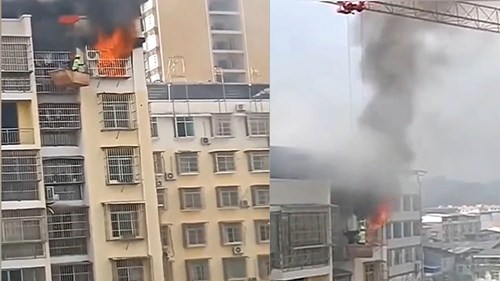 Công nhân dùng cần cẩu tháp cứu cậu bé bị kẹt trong căn hộ bốc cháy